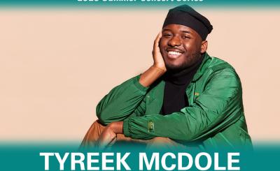 Tyreek McDole sitting down face resting on his palm, in green long sleeved shirt all in front a peach background